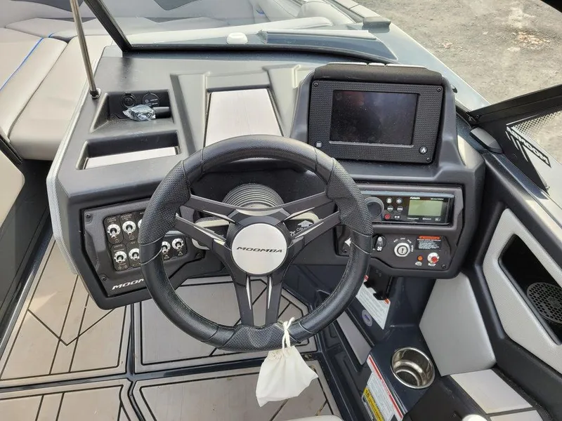 Slide: The Image of 2022 Moomba Makai boat dashboard with steering wheel and control panel. - 10