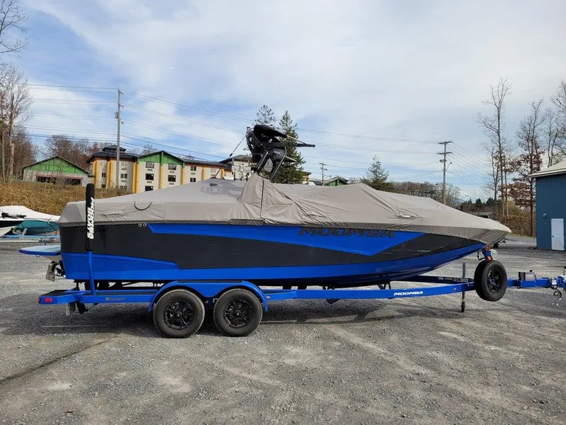 Slide: The Image of 2022 Moomba Makai boat on trailer, covered, in outdoor setting. - 15