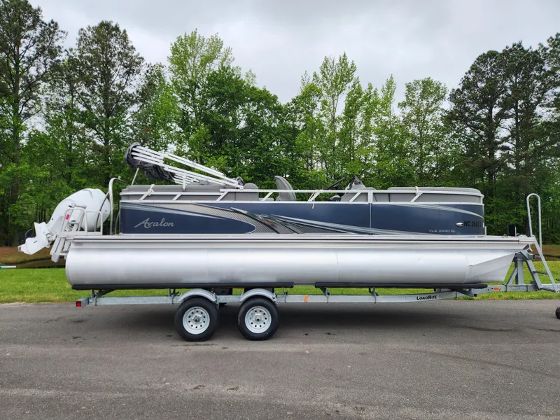 The Image of 2022 Avalon VLS 2280 QL pontoon boat on trailer, parked outdoors. - 0