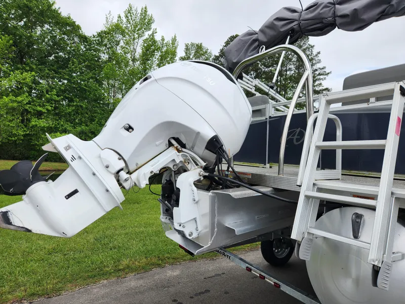 Slide: The Image of 2022 Avalon VLS 2280 QL pontoon boat with outboard motor, parked on a trailer. - 3