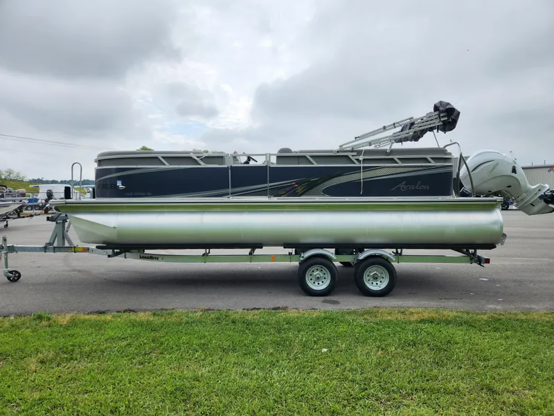 Slide: The Image of 2022 Avalon VLS 2280 QL pontoon boat on trailer, parked outdoors. - 5
