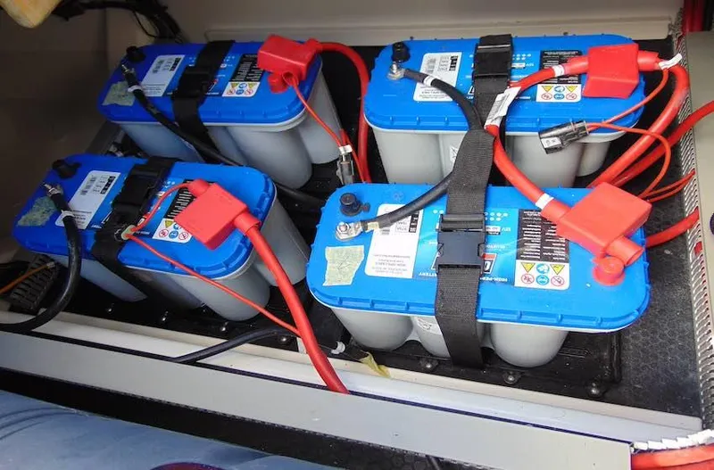 Slide: The Image of Four blue car batteries with red cables in a Navan C30, 2025 model. - 16