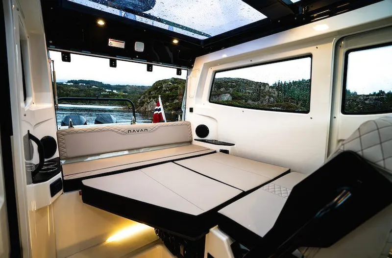 Slide: The Image of Interior of 2025 Navan C30 boat with modern seating and scenic window view. - 6