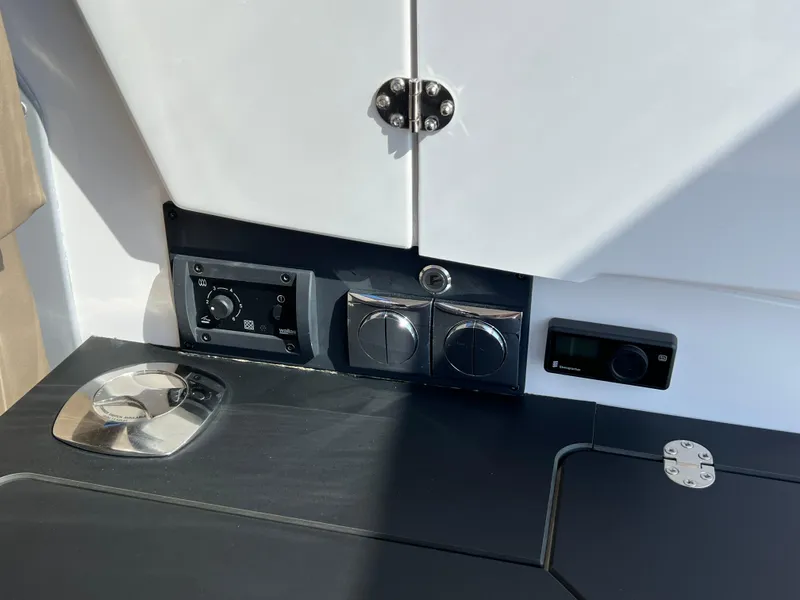 Slide: The Image of Control panel of 2024 Aquador 250 HT boat with sleek design elements. - 14