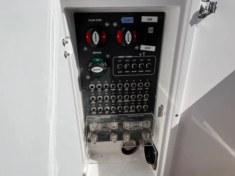 Slide: The Image of Control panel of 2024 Aquador 250 HT boat, featuring switches and circuit breakers. - 15