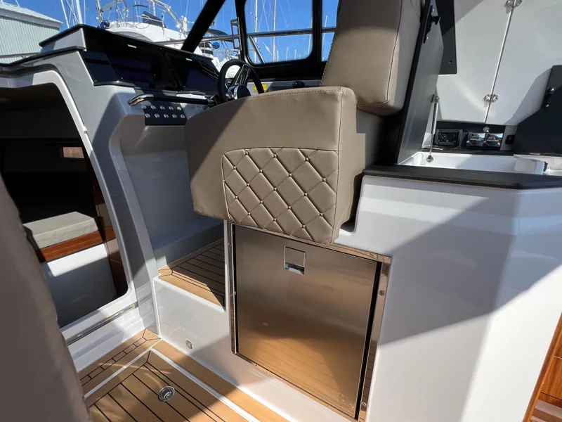 Slide: The Image of Interior of 2024 Aquador 250 HT boat, featuring modern seating and sleek design elements. - 16