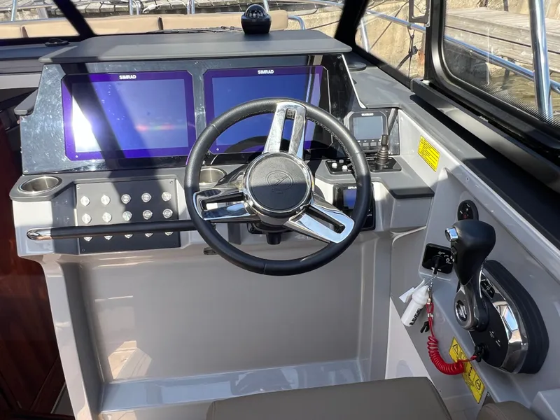 Slide: The Image of 2024 Aquador 250 HT helm with dual screens and modern steering wheel. - 22