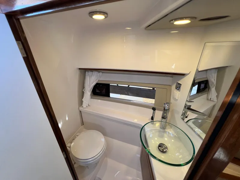 Slide: The Image of 2024 Aquador 250 HT boat bathroom with modern sink and toilet. - 26