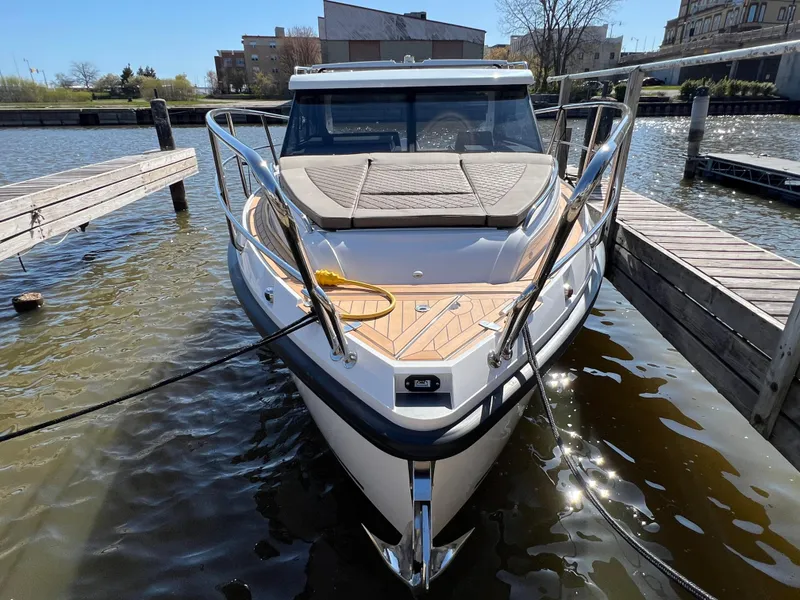 Slide: The Image of 2024 Aquador 250 HT boat docked at a marina, front view. - 3