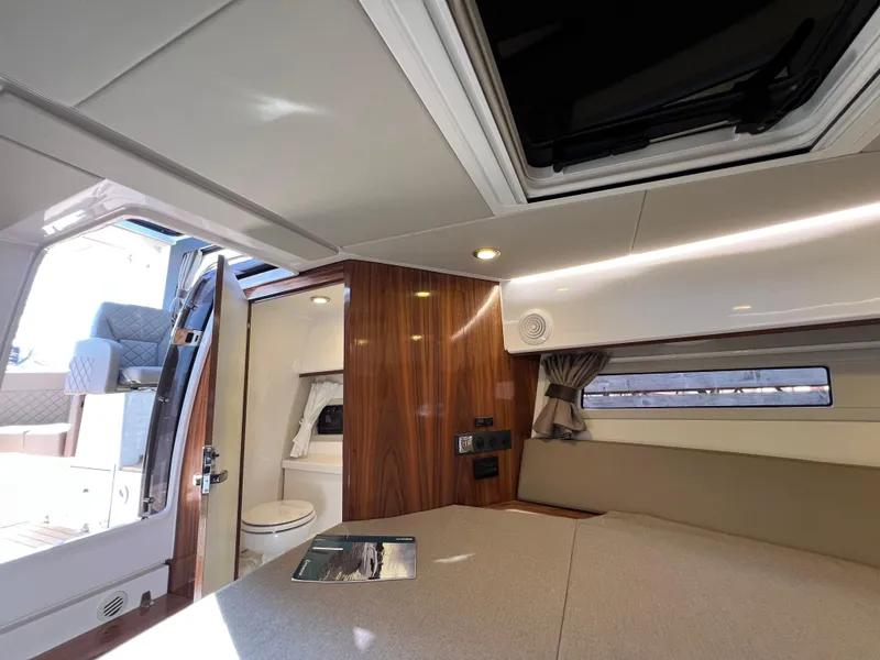 Slide: The Image of 2024 Aquador 250 HT interior cabin with modern design and natural light. - 30