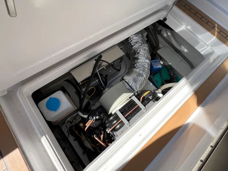 Slide: The Image of Engine compartment of 2024 Aquador 250 HT boat, showcasing mechanical components and ventilation system. - 33