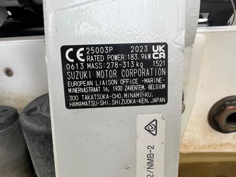 Slide: The Image of Label on Suzuki motor, 2023, showing specifications and European liaison office details. - 37