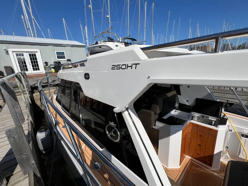 Slide: The Image of 2024 Aquador 250 HT boat docked at marina, showcasing sleek design and modern features. - 6