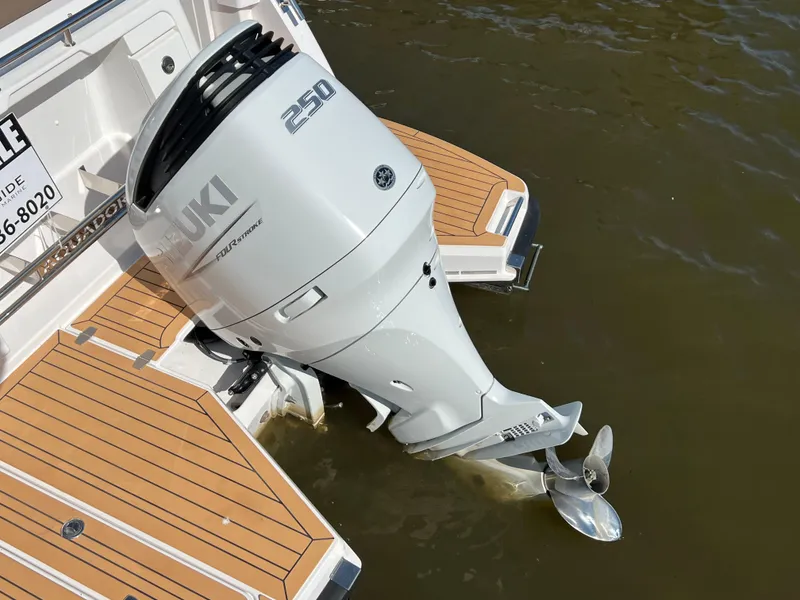 Slide: The Image of 2024 Aquador 250 HT with Suzuki 250 outboard motor on teak deck. - 9