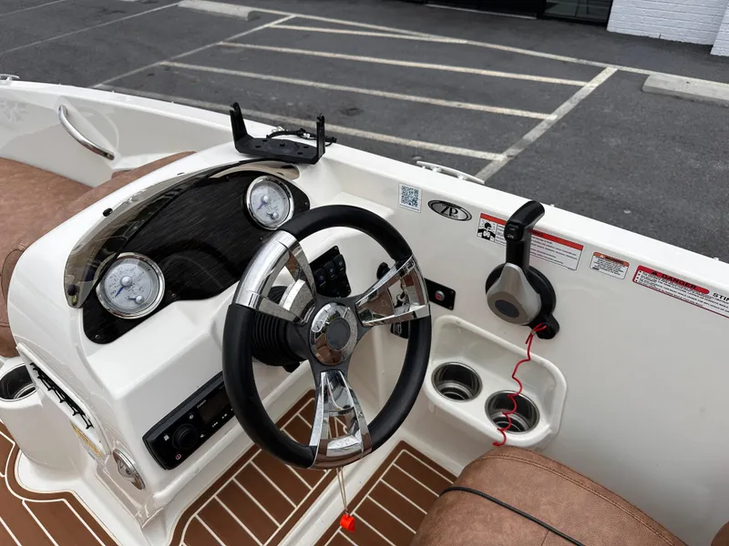Slide: The Image of 2020 Stingray 182 SC boat dashboard with steering wheel and gauges. - 10