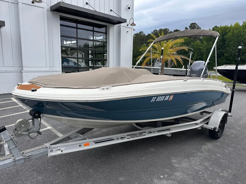 Slide: The Image of 2020 Stingray 182 SC boat on trailer, parked outdoors near a building. - 3