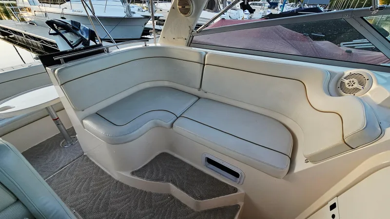 Slide: The Image of 2005 Rinker 300 Express Cruiser interior seating area with beige upholstery. - 11