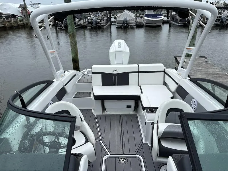 Slide: The Image of 2022 Monterey M-225 boat interior with seating, docked at marina. - 10