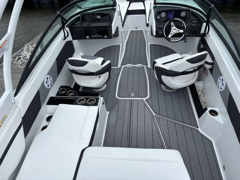 Slide: The Image of 2022 Monterey M-225 boat interior with sleek seating and modern dashboard design. - 11