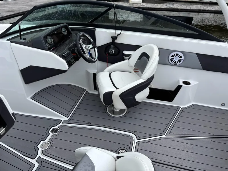 Slide: The Image of 2022 Monterey M-225 boat interior with sleek dashboard and comfortable seating. - 14
