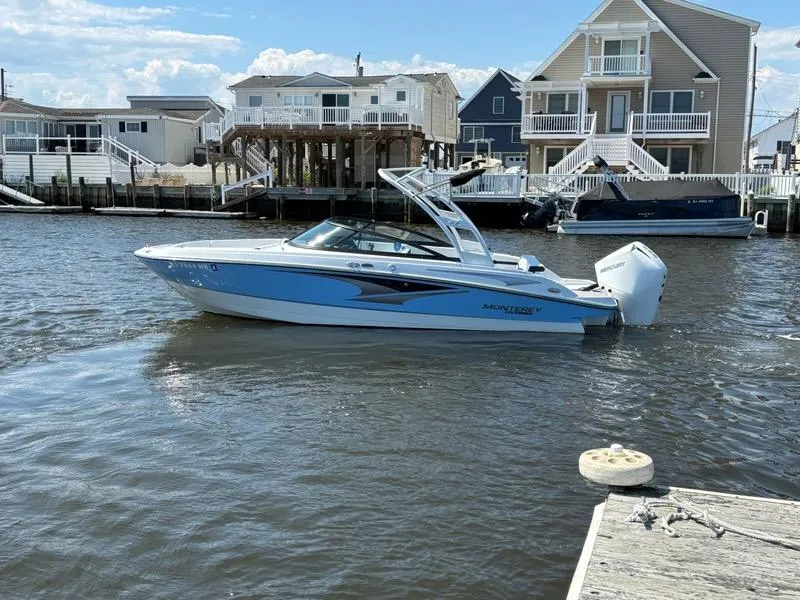 Slide: The Image of 2022 Monterey M-225 boat docked in a residential waterfront area. - 3