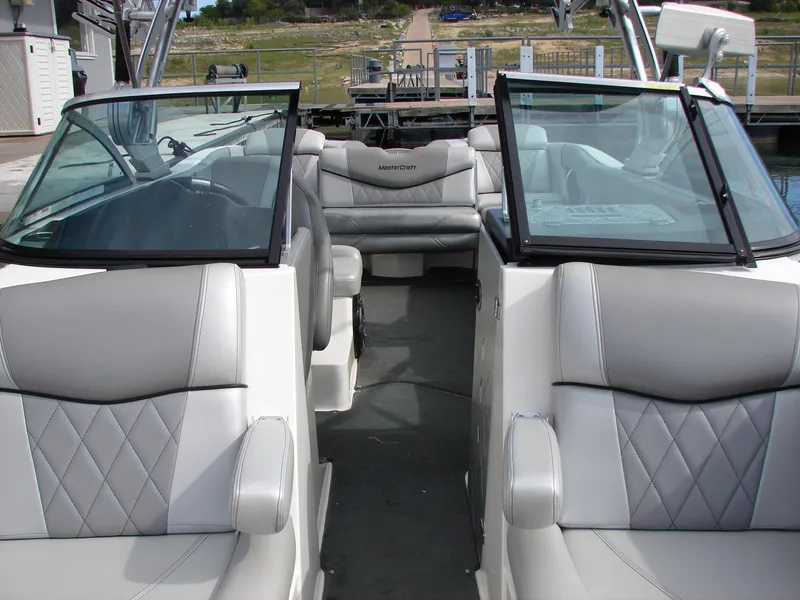 Slide: The Image of 2014 MasterCraft X46 boat interior with gray seating and open cockpit view. - 10