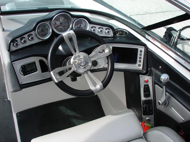 Slide: The Image of 2014 MasterCraft X46 boat dashboard with steering wheel and control panel. - 12