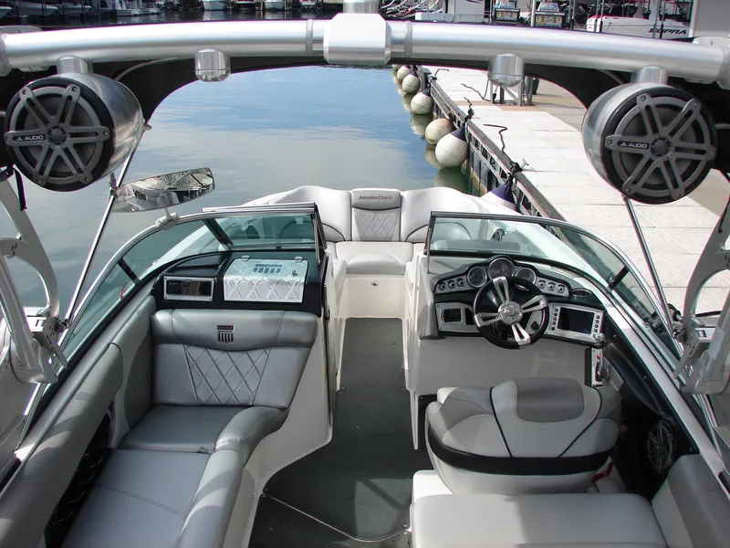 Slide: The Image of 2014 MasterCraft X46 boat interior with sleek seating and advanced dashboard controls. - 13