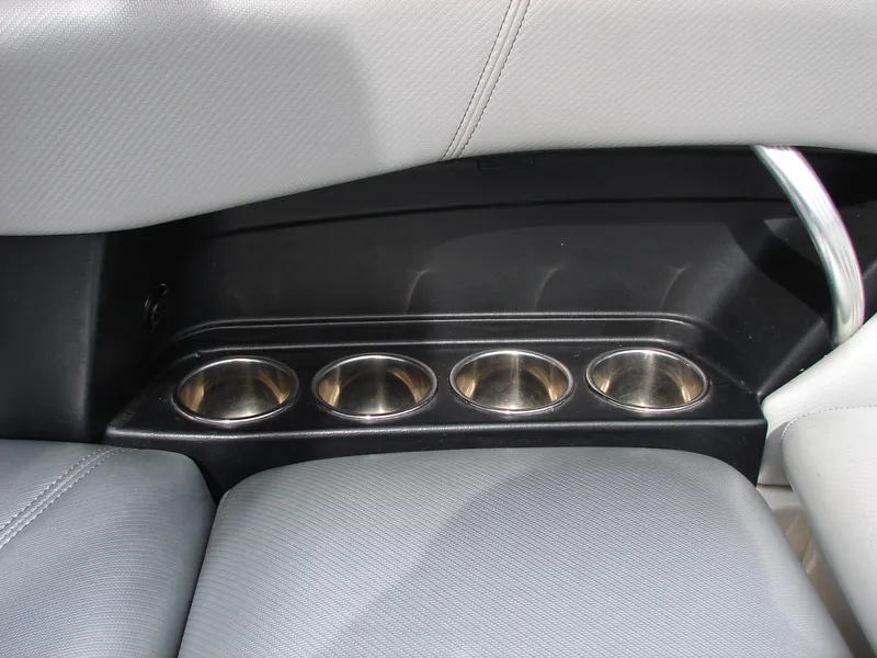 Slide: The Image of 2014 MasterCraft X46 boat interior with four cup holders and gray seating. - 16