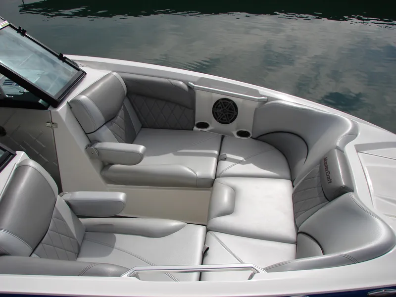 Slide: The Image of 2014 MasterCraft X46 boat interior with luxurious gray seating and cup holders. - 18