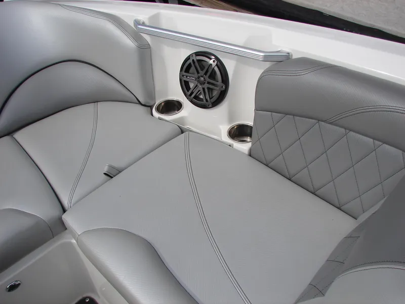 Slide: The Image of 2014 MasterCraft X46 boat interior with gray leather seats, speaker, and cup holders. - 9