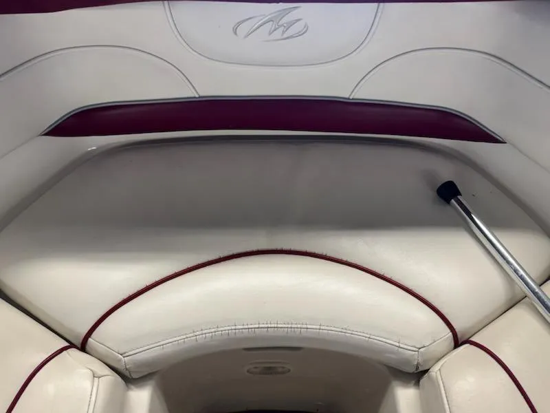 Slide: The Image of Interior seating of a 2006 Monterey 234FS boat with white and maroon upholstery. - 11