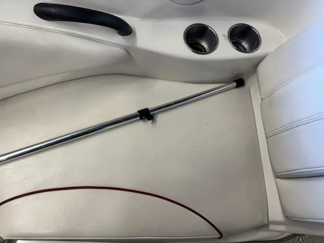 Slide: The Image of Interior of a 2006 Monterey 234FS boat with cup holders and seating. - 12