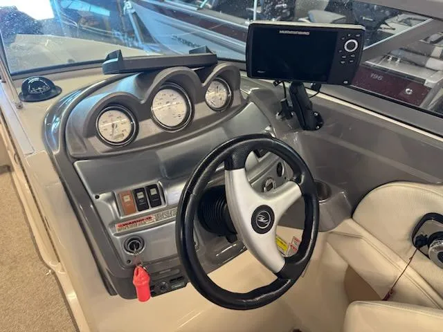 Slide: The Image of Dashboard of a 2006 Monterey 234FS boat with steering wheel and gauges. - 14