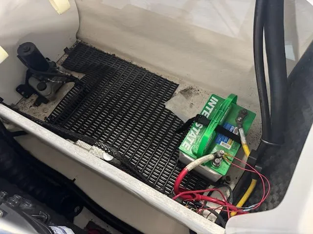 Slide: The Image of Battery compartment of a 2006 Monterey 234FS boat with wiring and mat. - 19