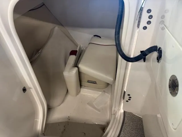 Slide: The Image of Interior cabin of a 2006 Monterey 234FS boat, featuring seating and storage. - 23