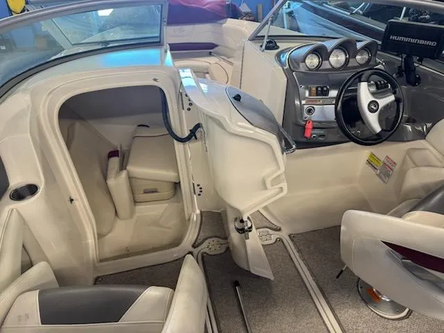 Slide: The Image of Interior of a 2006 Monterey 234FS boat, featuring steering wheel and seating area. - 24