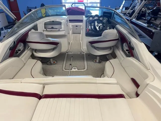 Slide: The Image of Interior of a 2006 Monterey 234FS boat with white and maroon seating. - 26