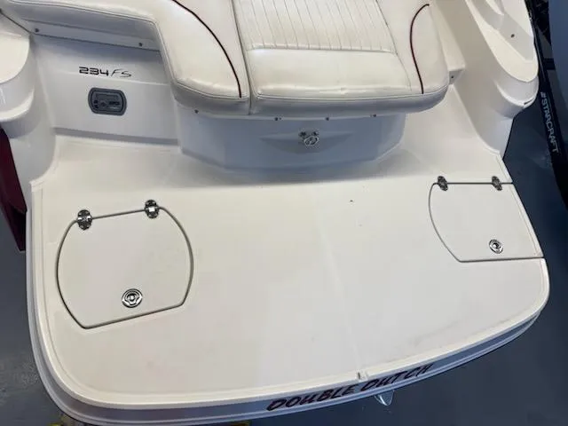 Slide: The Image of 2006 Monterey 234FS boat deck with seating and storage compartments. - 27