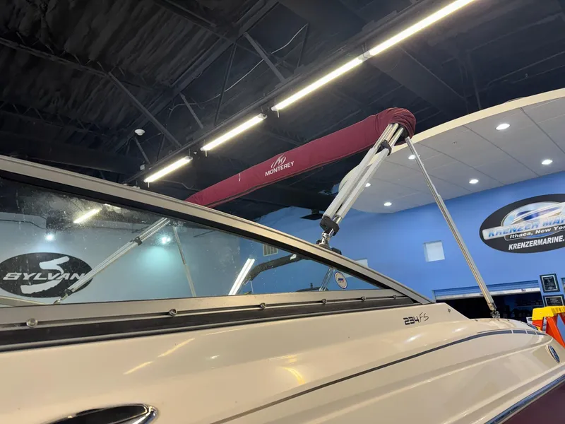 Slide: The Image of 2006 Monterey 234FS boat with maroon canopy in showroom. - 30
