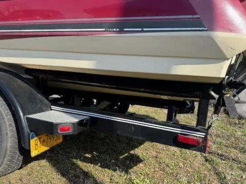 Slide: The Image of 2006 Monterey 234FS boat on trailer, red and white hull, parked on grass. - 8