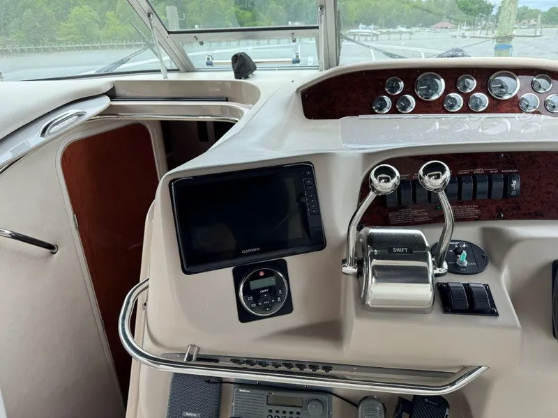 Slide: The Image of 1999 Sea Ray 330 Sundancer helm with navigation controls and gauges. - 12
