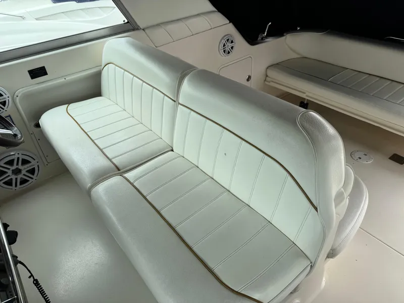Slide: The Image of 1999 Sea Ray 330 Sundancer interior with white leather seating and speaker system. - 14