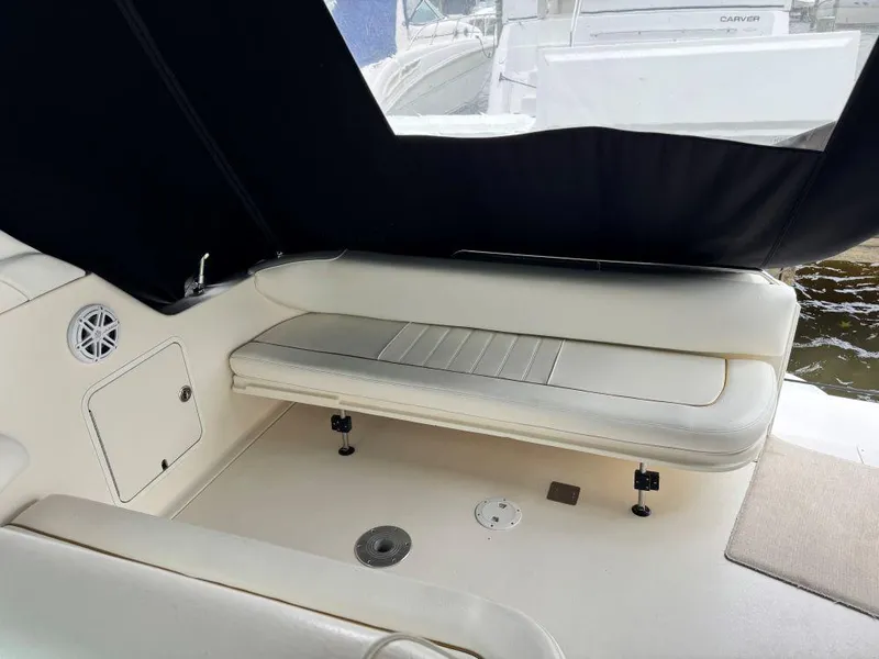 Slide: The Image of 1999 Sea Ray 330 Sundancer interior with white seating and black canopy. - 15