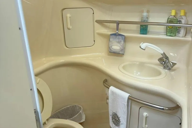 Slide: The Image of 1999 Sea Ray 330 Sundancer bathroom with sink, faucet, and toiletries. - 18
