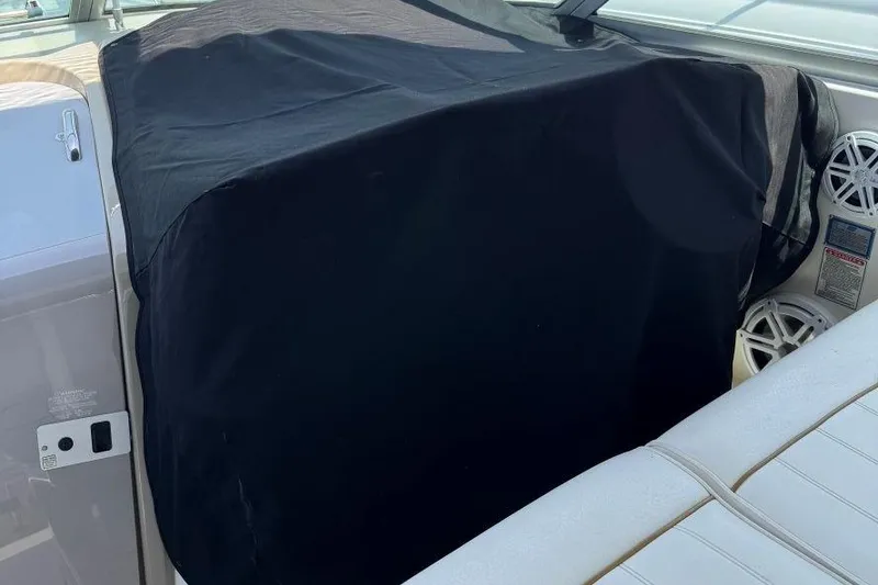 Slide: The Image of 1999 Sea Ray 330 Sundancer cockpit with black cover and white seating. - 20