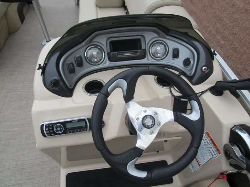 Slide: The Image of 2019 Sun Tracker SPORT FISH 22 XP3 dashboard with steering wheel and control panel. - 12