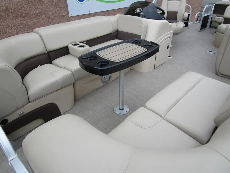 Slide: The Image of 2019 Sun Tracker SPORT FISH 22 XP3 pontoon boat interior with beige seating and table. - 5