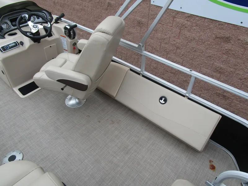 Slide: The Image of 2019 Sun Tracker SPORT FISH 22 XP3 boat interior with beige seating and steering console. - 7