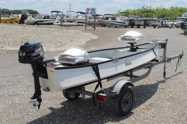 Slide: The Image of 2006 Gheenoe 13 boat on trailer with Honda 6.0 motor, parked in a boatyard. - 4